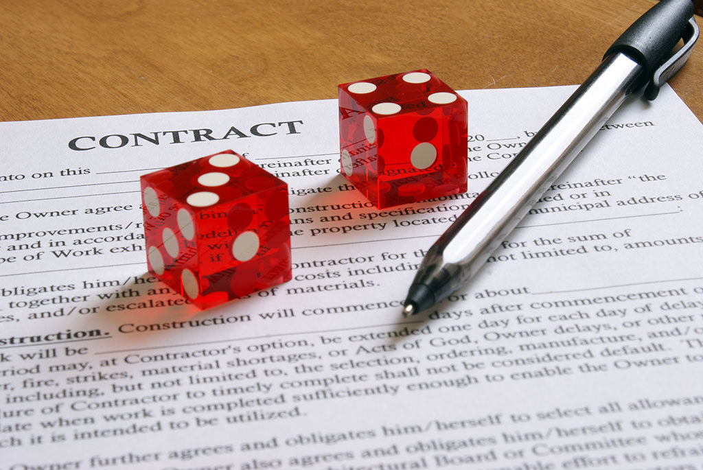 a contract with a pen and dice